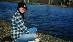 Girl sitting by water