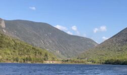 lake with mountains in the background.